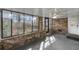 An enclosed sunroom features brick walls, large windows, and a ceiling fan for a relaxing atmosphere at 3063 Randolph Ne Rd, Atlanta, GA 30345