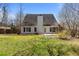 Back of the home with large backyard, patio, and wooden fence at 3565 Mystic Dr, Buford, GA 30519