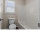 Bathroom with toilet, shower/tub combo with bright natural light from window at 3565 Mystic Dr, Buford, GA 30519