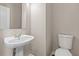 Bathroom featuring a pedestal sink and toilet at 3565 Mystic Dr, Buford, GA 30519