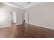 Spacious bedroom featuring wood floors, neutral walls, and access to the bathroom and hallway at 3565 Mystic Dr, Buford, GA 30519