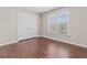 Bedroom with wood-look floors, a double door closet, and natural light from a window at 3565 Mystic Dr, Buford, GA 30519