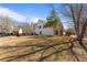 View of the side and rear of a white house with a large yard at 3565 Mystic Dr, Buford, GA 30519