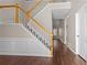 Bright foyer features a staircase with wooden railing and new hardwood flooring at 3565 Mystic Dr, Buford, GA 30519