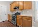 Well-lit kitchen with stainless steel appliances and wood cabinets at 3565 Mystic Dr, Buford, GA 30519