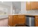 A well-lit kitchen featuring stainless steel appliances and wood cabinets at 3565 Mystic Dr, Buford, GA 30519