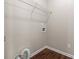 Small laundry room with wood look floors, neutral paint, and utility connections at 3565 Mystic Dr, Buford, GA 30519