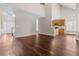 Open-concept living area with kitchen view, vaulted ceiling, and gorgeous new hardwood flooring at 3565 Mystic Dr, Buford, GA 30519