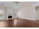 Light-filled living room boasts a vaulted ceiling, fireplace, and gleaming wood floors at 3565 Mystic Dr, Buford, GA 30519