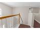 Staircase with wood railings, white balusters, neutral walls, and wood look flooring at 3565 Mystic Dr, Buford, GA 30519