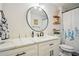 Bathroom featuring a round mirror above the sink and vanity, plus decor and blue floral shower curtain at 39 Saint Claire Ne Ln, Atlanta, GA 30324