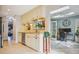 Cream colored kitchen showcasing stainless steel appliances and view of a bright sunroom at 39 Saint Claire Ne Ln, Atlanta, GA 30324