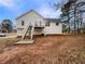 Rear exterior view of the home with a wooden deck and staircase at 17 Cedars Glen Pl, Villa Rica, GA 30180