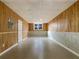 An unfinished basement features tile flooring, paneled walls, a door, and a window at 17 Cedars Glen Pl, Villa Rica, GA 30180