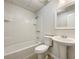 This bathroom includes a pedestal sink, a toilet, a shower head, and a tub at 17 Cedars Glen Pl, Villa Rica, GA 30180