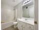 This bathroom features a vanity sink, large mirror, white cabinets, and a shower/tub combo at 17 Cedars Glen Pl, Villa Rica, GA 30180