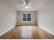 A spacious bedroom features a ceiling fan, hardwood floors, white walls, and a window at 17 Cedars Glen Pl, Villa Rica, GA 30180