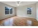 Bright bedroom with a large window, hardwood floors and ceiling fan at 17 Cedars Glen Pl, Villa Rica, GA 30180