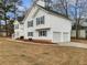 Charming two-story home with white siding, blue shutters, and attached two car garage at 17 Cedars Glen Pl, Villa Rica, GA 30180