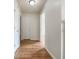 A hallway features hardwood floors, neutral paint, a ceiling light, and multiple doors at 17 Cedars Glen Pl, Villa Rica, GA 30180