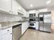 Well-lit kitchen with white cabinets, stainless steel appliances, and granite countertops at 17 Cedars Glen Pl, Villa Rica, GA 30180