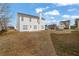 View of a spacious backyard and the exterior of the home with white siding and a classic architectural design at 2612 Kirkhill Ct, Lawrenceville, GA 30044