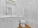 Bright bathroom featuring white cabinets, a toilet, and a shower with clear curtains at 2612 Kirkhill Ct, Lawrenceville, GA 30044