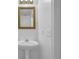 Bathroom featuring a decorative mirror, single sink and white pedestal at 2612 Kirkhill Ct, Lawrenceville, GA 30044