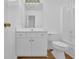 A well-lit bathroom with white cabinets, a commode and a shower at 2612 Kirkhill Ct, Lawrenceville, GA 30044