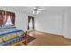 This bedroom features wood floors, a bed, two windows, and a ceiling fan at 2612 Kirkhill Ct, Lawrenceville, GA 30044