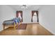 The bedroom showcases wood floors, a bed, two windows, and a ceiling fan at 2612 Kirkhill Ct, Lawrenceville, GA 30044