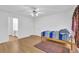 The bedroom boasts wood floors, a bed, two doors, and a ceiling fan at 2612 Kirkhill Ct, Lawrenceville, GA 30044