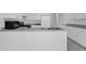 Kitchen featuring sleek stainless steel appliances, stylish gray countertops, and white cabinets at 2612 Kirkhill Ct, Lawrenceville, GA 30044