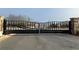 Black iron gates with stone columns mark the entrance to the community at 1279 Lakeside Overlook, Canton, GA 30114