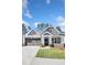 Charming gray home featuring a two-car garage, a covered entryway, and a well-manicured lawn at 1279 Lakeside Overlook, Canton, GA 30114