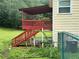 View of the back deck with stairs leading to a yard surrounded by lush greenery and mature trees at 1931 Harvest Way, Loganville, GA 30052