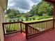Spacious back deck overlooking the fenced pool, lush landscaping and mature trees in the backyard at 1931 Harvest Way, Loganville, GA 30052