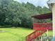 Spacious backyard with a bright-red wooden deck, perfect for entertaining and relaxing at 1931 Harvest Way, Loganville, GA 30052