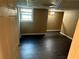 Bedroom with dark wood-look flooring, neutral paint, closet and a window provides comfort at 1931 Harvest Way, Loganville, GA 30052