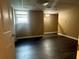Bedroom with dark wood-look flooring, neutral paint, closet and a window provides comfort at 1931 Harvest Way, Loganville, GA 30052