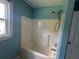 Bathroom featuring a white shower/tub combo and a window at 1931 Harvest Way, Loganville, GA 30052