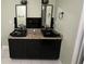 Bathroom with a double sink vanity with granite counters and dark cabinets at 1931 Harvest Way, Loganville, GA 30052