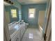 Bathroom featuring a double sink vanity, toilet, and shower/tub combo at 1931 Harvest Way, Loganville, GA 30052