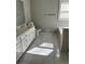 Bathroom with white cabinets and drawers, vanity top, and white ceramic tiles at 1931 Harvest Way, Loganville, GA 30052