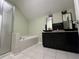 Bathroom featuring a shower, tub, and single vanity with a dark cabinet at 1931 Harvest Way, Loganville, GA 30052