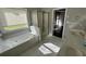 Bright bathroom features a jetted tub, glass shower, and double vanity with white countertops at 1931 Harvest Way, Loganville, GA 30052