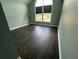 Bedroom with large window offering scenic views and dark wood floors at 1931 Harvest Way, Loganville, GA 30052