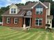 Charming two-story brick home showcases manicured lawn and tasteful siding accents for added appeal at 1931 Harvest Way, Loganville, GA 30052
