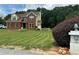 Well-maintained two-story brick home with manicured lawn, showcases a beautiful blend of brick and siding at 1931 Harvest Way, Loganville, GA 30052