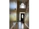 Grand two-story foyer with staircase, hardwood floors, and decorative window above the front door at 1931 Harvest Way, Loganville, GA 30052